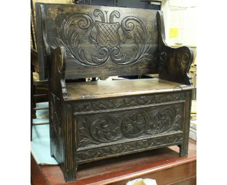 A collection of furniture comprising a circa 1900 carved oak monk's settle in the Gothic Revival taste, a late Victorian pine