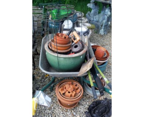 Two 19th Century cast iron boot scrape together with a  collection of garden pots, two wheelbarrows, three chimney pots, vari