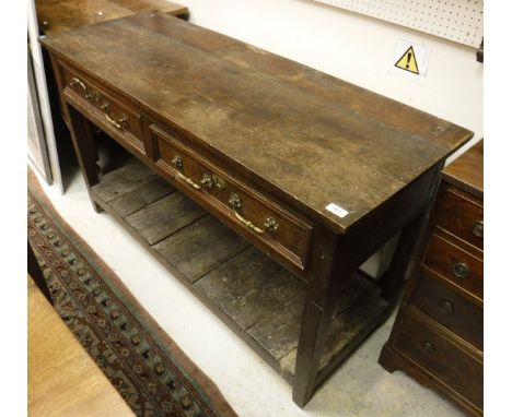 A 19th Century oak dresser, the plain top above two drawers over square tapered legs united by a pot shelf