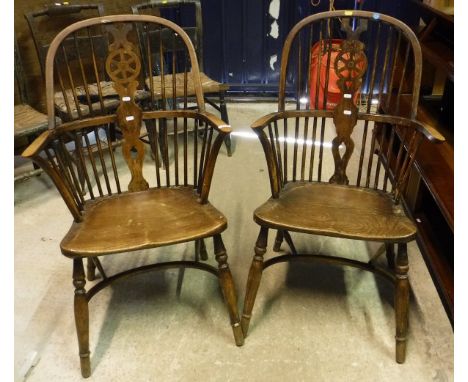Two circa 1900 Thames Valley wheel and stick back elbow chairs on turned legs each united by crinoline stretchers