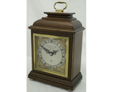 An Elliott mahogany cased mantle clock with Roman numerals to the steel dial, housed in original box, retailed by Garrard and