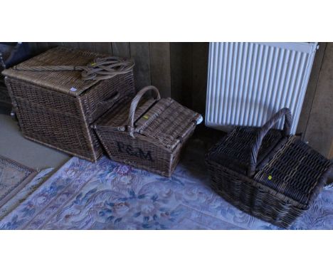 A wicker twin handled basket, together with a wicker Fortnum and Mason picnic hamper and a further wicker hamper, and a caned