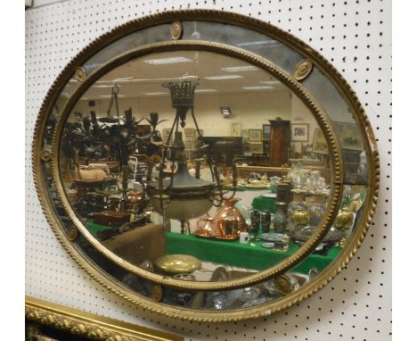 An oval multi-plate wall mirror with gesso moulded frame and a further mirror