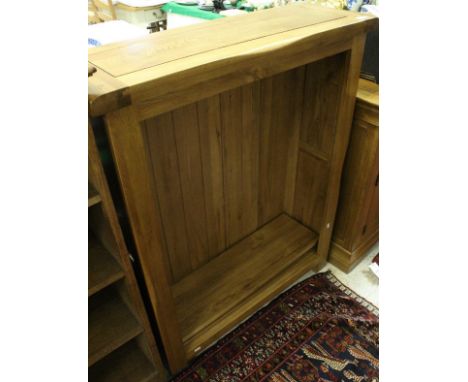 A modern oak bookcase, together with matching sideboard, the plain top above three short drawers above three cupboard doors t