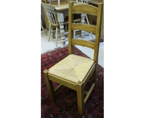 A set of six modern beech framed ladder back chairs with rush seats