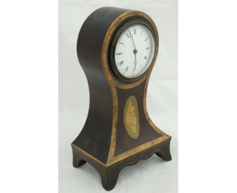 A circa 1900 mahogany banded and inlaid balloon shaped mantle clock with Roman numerals to the enamelled dial, with conch she