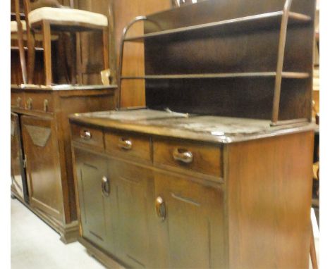 An Ercol oval drop-leaf dining table and set of four chairs, together with a dresser with two tier plate rack over three draw