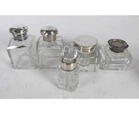 An early 20th century silver topped cut glass inkwell; together with another silver mounted inkwell, two silver topped dressi