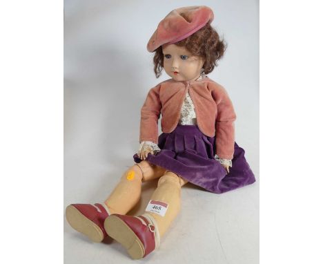 A Heinrich Handwerck German bisque headed doll, having rolling blue glass eyes, and showing four upper teeth, articulated lim