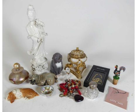 A collection of miscellaneous items to include a blanc de chine model of Guan Yin, a Royal Copenhagen figure of a cat in seat