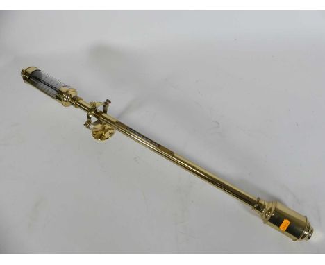A modern brass wall hanging barometer