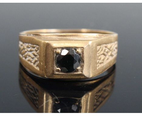 A modern gent's 9ct gold garnet set signet ring, the shoulders with carved detail, size W, 4.3g 