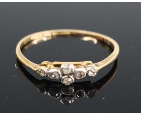 A yellow and white metal diamond half hoop ring, having six Old European cut diamonds in bezel settings, total weight estimat