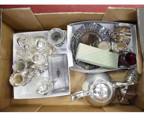 A box of assorted silver plated wares to include table cigarette case, four bottle cruet, teapot, lighthouse sugar sifter etc