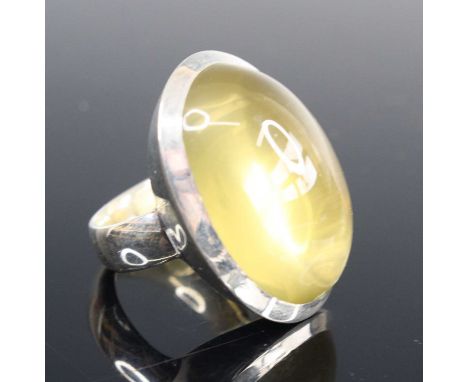 A contemporary silver and cabochon green stone set dress ring, sponsor YC, size P, 19.4g