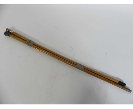A silver topped swagger stick together with a silver topped walking cane