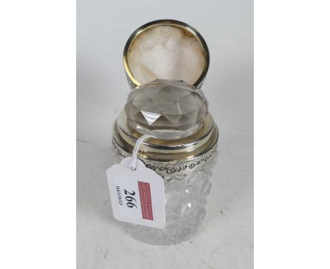 A Victorian scent bottle, having a hobnail cut glass body, with hinged silver cover having floral repousse decoration, h.11cm