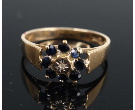 A 9ct yellow gold, sapphire and diamond reverse cluster ring, with eight 2.4mm round sapphires, total weight estimated as 0.4