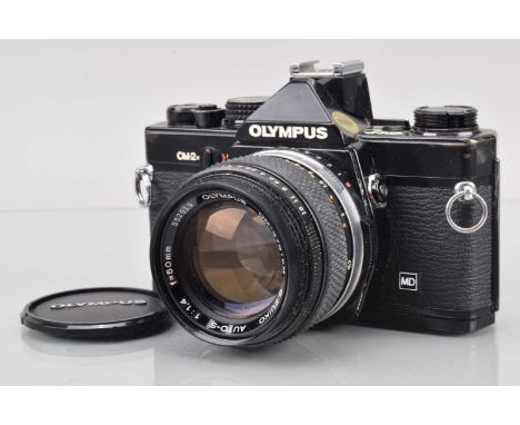 An Olympus OM-2n MD SLR Camera, black, shutter working, meter responsive, responsive in auto, self timer working, body G, pai