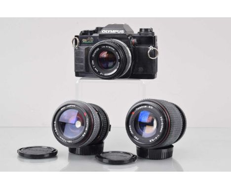 An Olympus OM-40 Program SLR Camera, shutter working, meter responsive, responsive in auto, self timer working, body G, with 