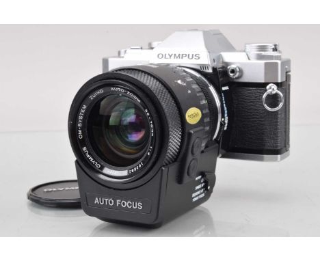 An Olympus OM-30 SLR Camera, shutter working, meter responsive, responsive in auto, self timer working, with Zukio Auto-Zoom 