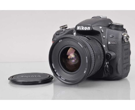 A Nikon D7000 DSLR Camera, shutter working, flash working, responsive in modes, menu screen working, body G-VG, with battery,