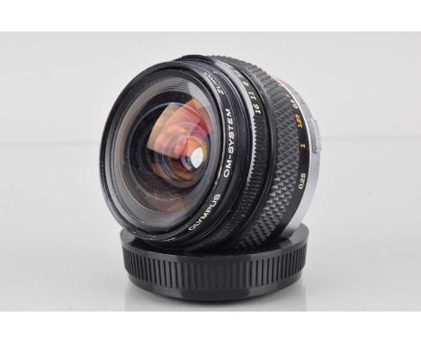An Olympus OM Zuiko MC Auto-W 18mm f/3.5 Lens, barrel G, slight paint wear to aperture grip, small paint scratch to filter ri