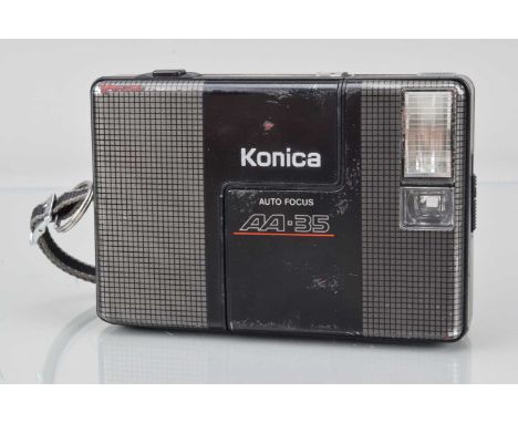 A  Konica AA-35 Half Frame Camera, grey, shutter working, flash working, exposure light working, body F-G, some scratches and