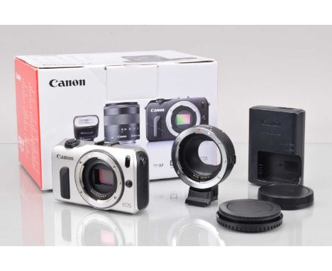 A Canon EOS M Digital Camera Body, silver, shutter working, touch screen working, responsive in settings, body G-VG, with Vil