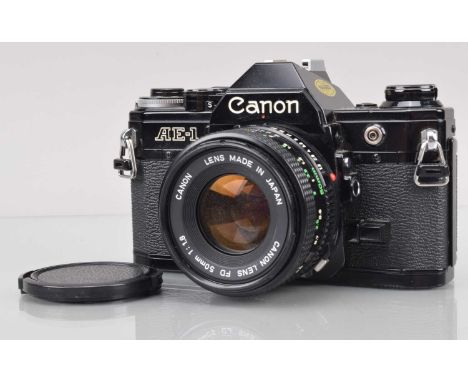 A Canon AE-1 SLR Camera, black, shutter working, meter responsive, self timer working, body G, with FD 50mm f/1.8 lens, barre