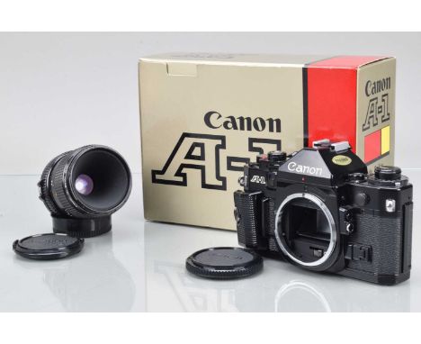 A Canon A-1 SLR Camera, black, shutter working (with squeak), meter responsive, self timer working, body VG, in maker's box, 