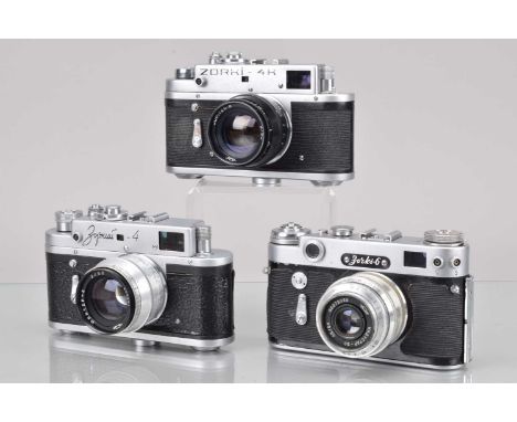 Three Zorki Rangefinder Cameras, a Zorki 4, shutter curtain slow to close, self timer working, rangefinder working, body G, w