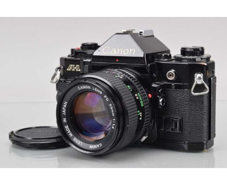 A Canon A-1 SLR Camera, black, shutter working, meter responsive, responsive in auto, self timer working, body G, some brassi