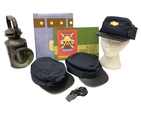 Black painted three colour railway lamp with revolving filters, H29cm; BR Acme Thunderer whistle; three railway peaked caps, 