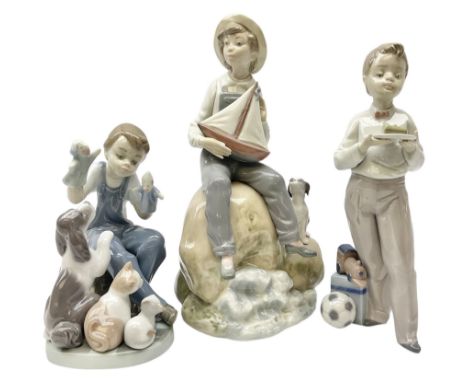 Three Lladro figures, comprising Guest of Honor no 5877, Boy with Boat no 5166 and Puppet Show no 5736, all with original box