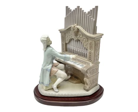 Lladro figure, Young Bach, modelled as a young Johann Sebastian Bach playing the piano, on a mahogany oval base, limited edit