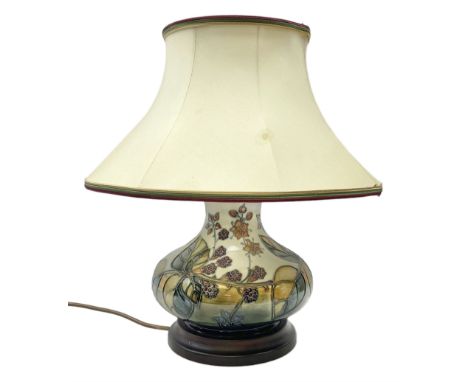 Moorcroft table lamp of squat baluster form, decorated in the Autumn Blackberry, with Moorcroft cream fabric shade with gold,