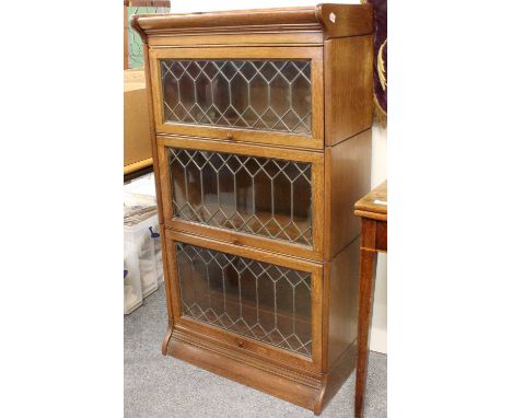 An Oak Globe Wernicke Style Three Tier Bookcase with leaded glass doors