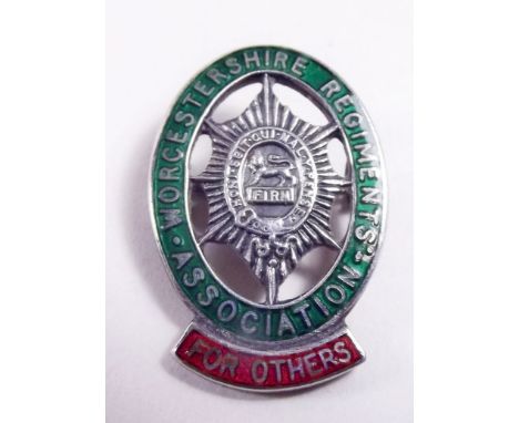 A silver Royal Worcester regimental badge