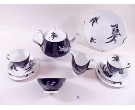 A Royal Albert 'Night & Day' teaset comprising: six cups and saucers (two cups a/f), cake plate, teapot, six tea plates, milk