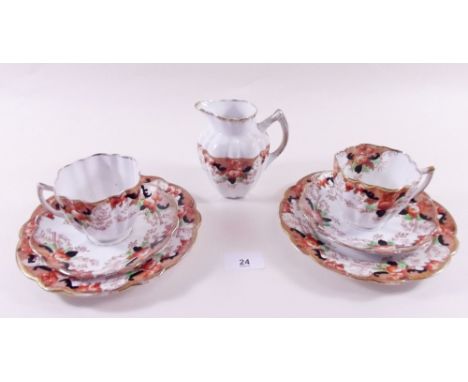 A Melba Edwardian teaset comprising:- six cups and saucers, six tea plates, cake plate and a jug