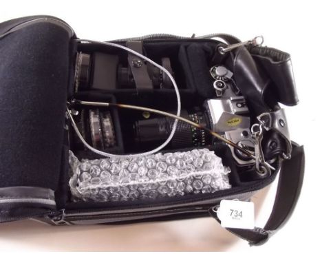 A Canon AE-I camera with 1:3.5 lens and other lenses and accessories in case