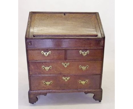 A George II oak bureau, the slope front enclosing fitted interior of pigeon holes over well (slide missing), the base with tw