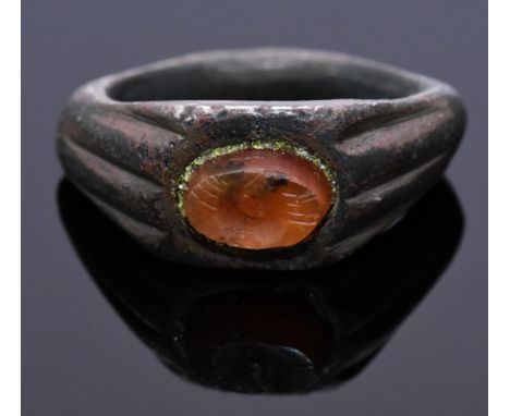 A carnelian intaglio ring with shrimps depicted on bezel; D-shaped band with decorated shoulders. Possibly owned by a fisherm