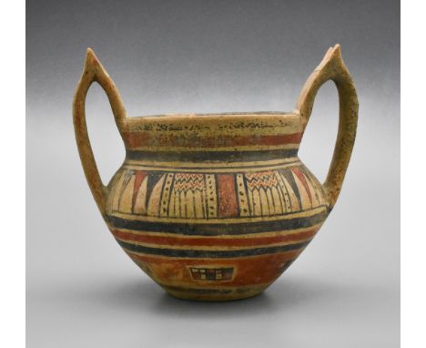 Daunian krater with horn shaped handles. ‘Apulia c. 6th to 3rd century BC. Light orange clay krater with two high handles sur