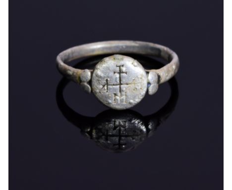 A Crusaders silver ring with a religious monogram on bezel; intact oval shaped band. Possibly worn by a knight in the holy la