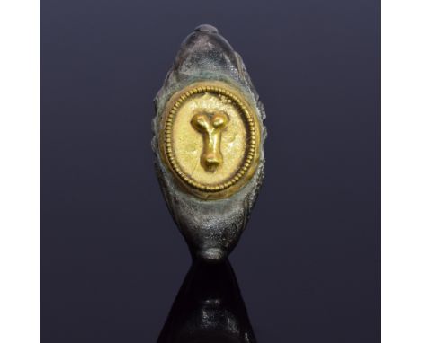 A substantial silver ring with a gold bezel depicting phallus; d-shaped band with decoration. Such rings were commonly worn b