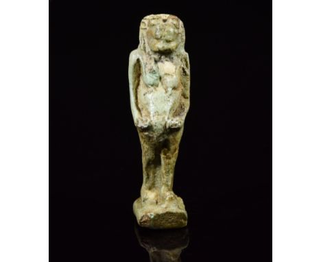 An amulet moulded in a light green faience in the form of the hippopotamus deity Tauret. Tauret is shown with her hands by he
