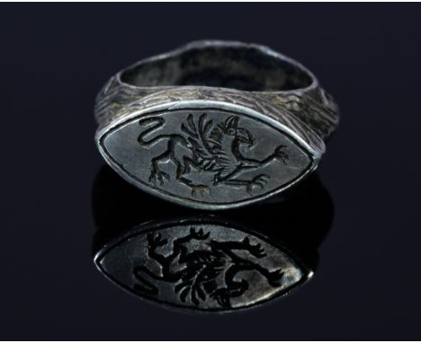 Very Large Roman Legionary seal ring with Griffin depicted on a large elliptical shaped bezel; The band and shoulders are ela