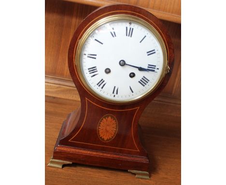 A 20th century mahogany balloon shaped mantle clock, the enamel dial with Roman numerals, the waisted base inlaid with a flow
